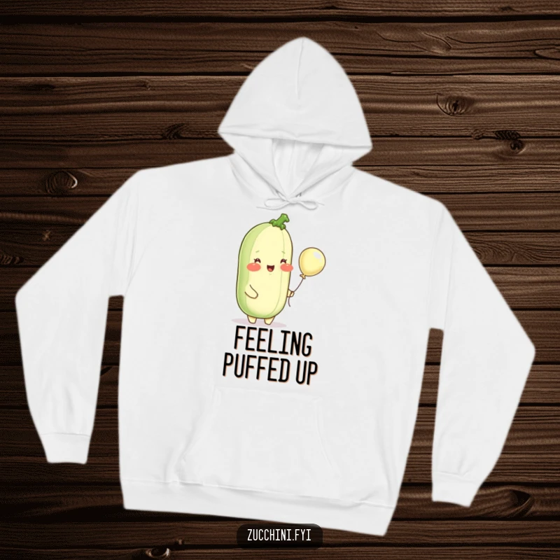 Funny hoodie, a delighted zucchini with rosy cheeks holding a tiny balloon, perfect for cozy, cheerful lounging.