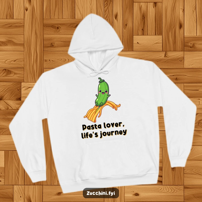 Happy zucchini sliding down a rainbow made of pasta, a cozy and humorous hoodie.