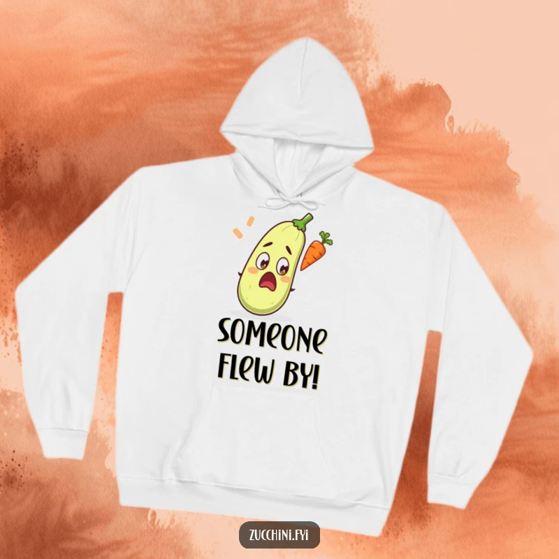 Funny hoodie depicting a wide-eyed, surprised zucchini in mid-reaction to an acrobatic flying carrot.