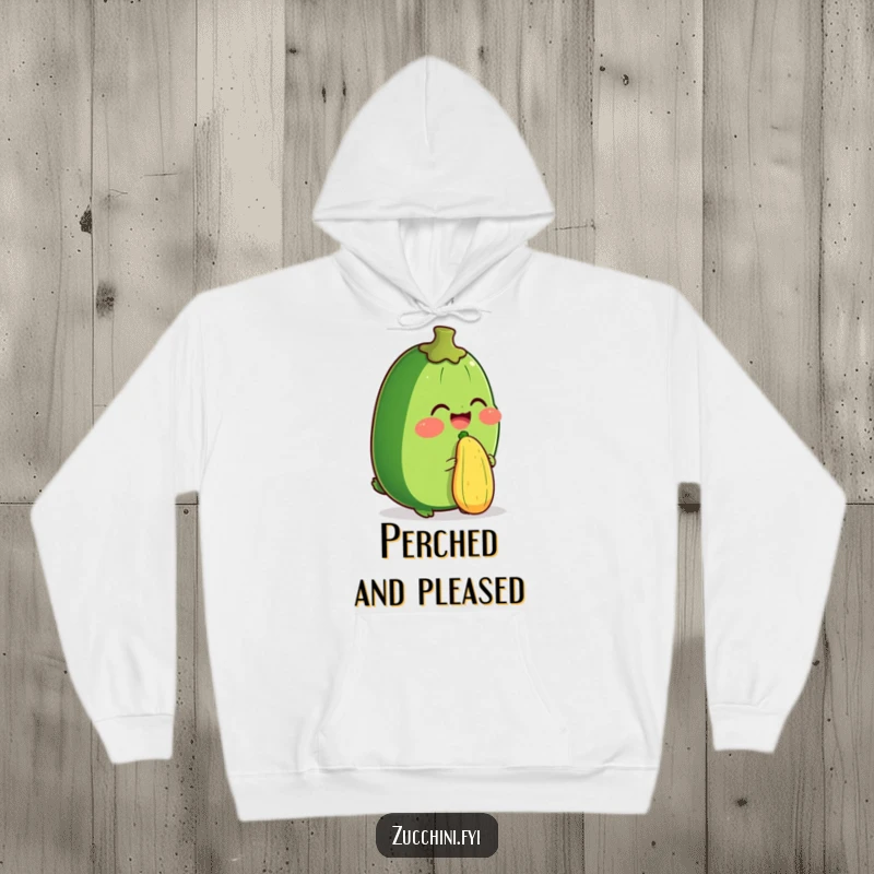 Funny hoodie showing a zucchini character laughing while balancing a small zucchini on its nose. Comfortable and comical.
