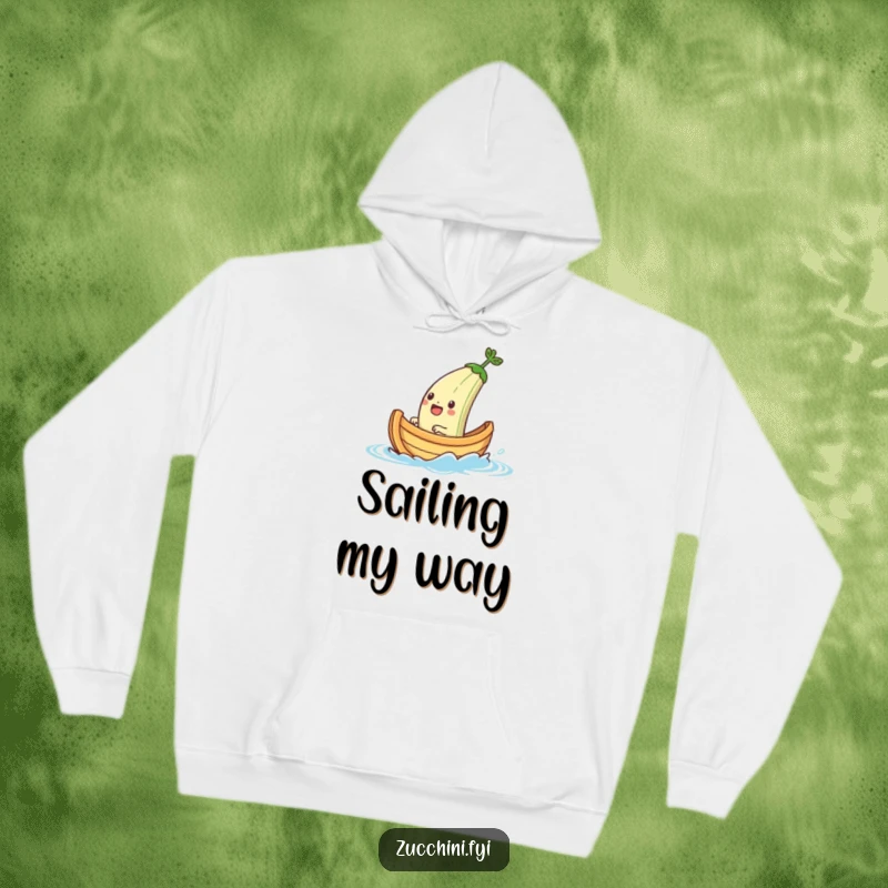 Funny hoodie depicting a jubilant zucchini boat character embarking on a tiny water voyage, offering cozy warmth and nautical humor.