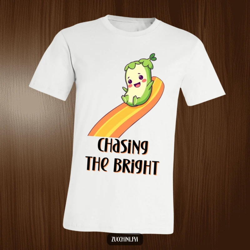 Funny T-shirt showing a zucchini character happily sliding down a colorful rainbow, depicting a sense of joy, freedom, and whimsical delight.